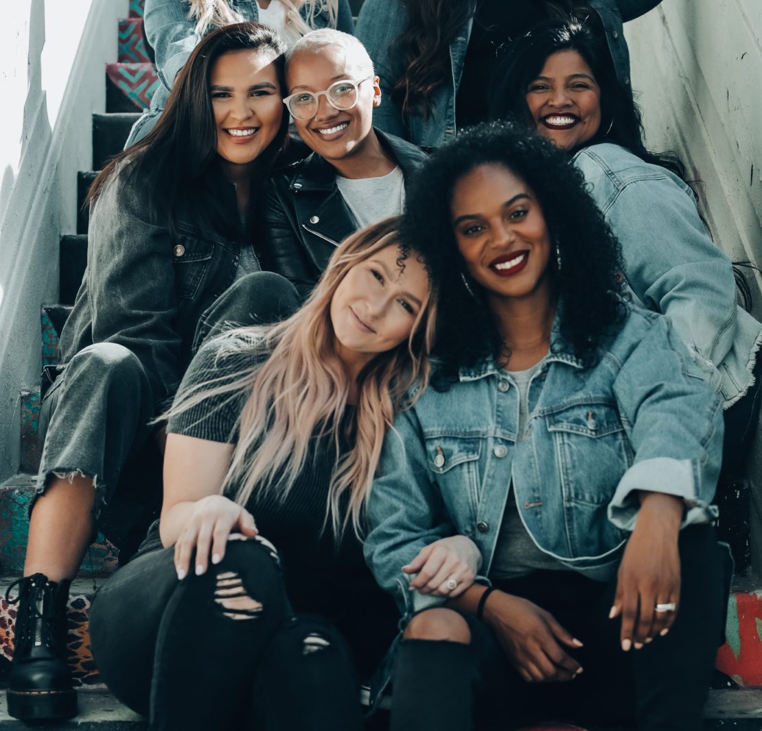2 women sitting on black chair