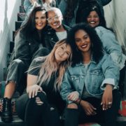 2 women sitting on black chair