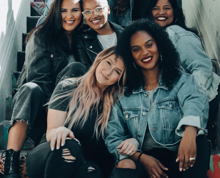 2 women sitting on black chair