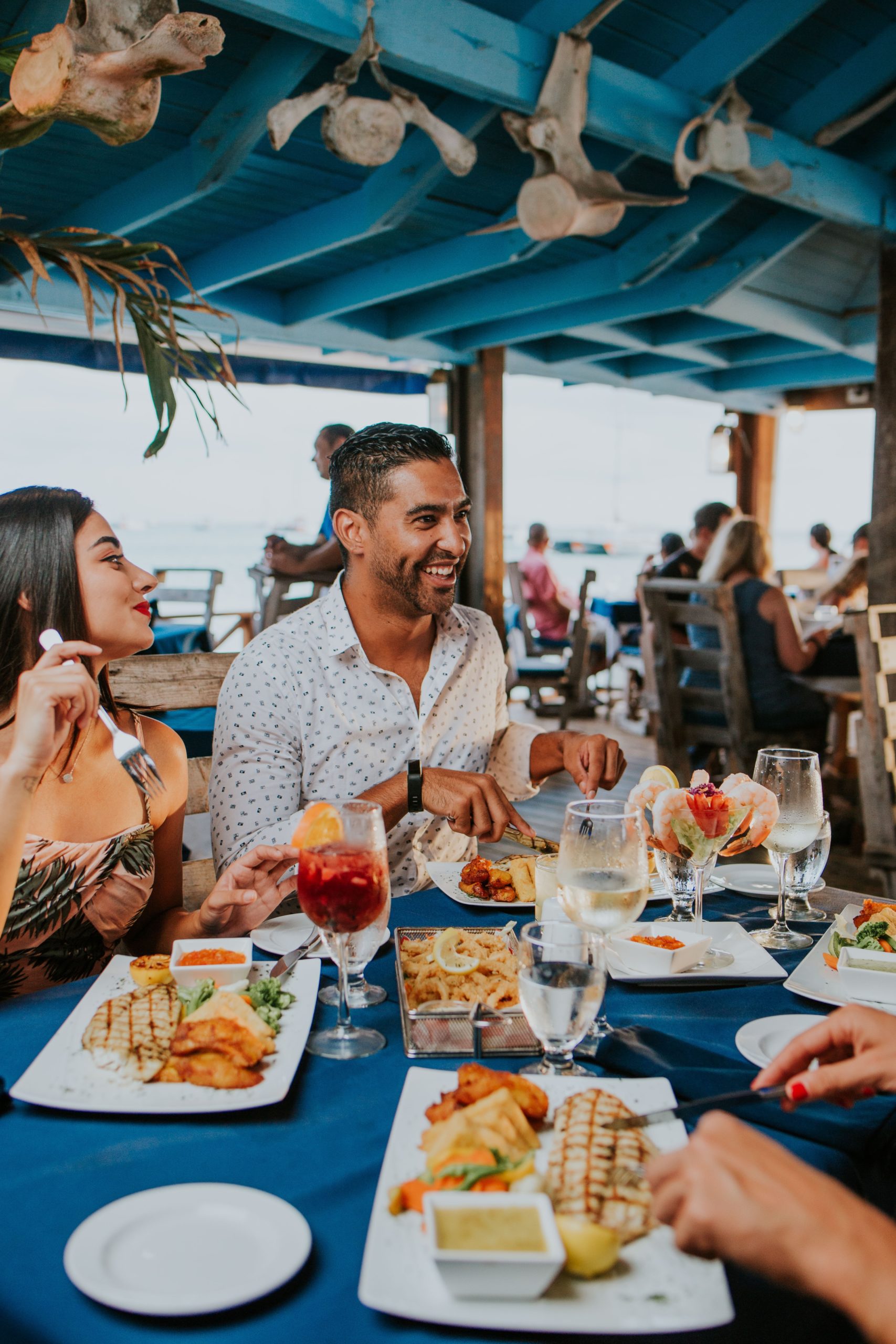 man and woman sitting on chair in front of table with food on top