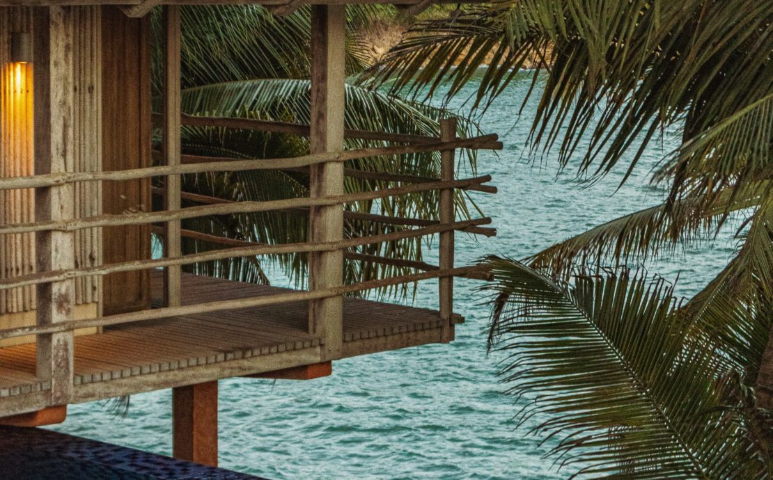 brown wooden gazebo on body of water during daytime
