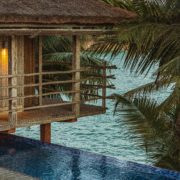 brown wooden gazebo on body of water during daytime